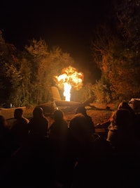 a group of people watching a fire