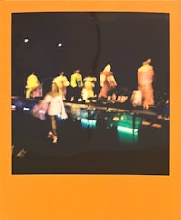 polaroid of a group of people on stage