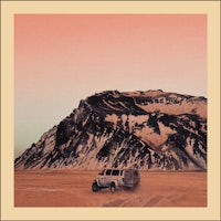 an image of a truck in the desert with mountains in the background