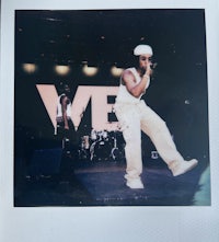 a photo of a man on stage with a microphone