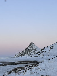 a man is skiing down a snow covered mountain