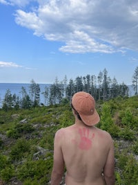 a man with a red hand painted on his back