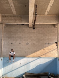 a man on a skateboard on a concrete floor